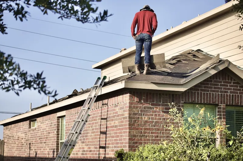 Professional roofer working on a residential roof in Helen